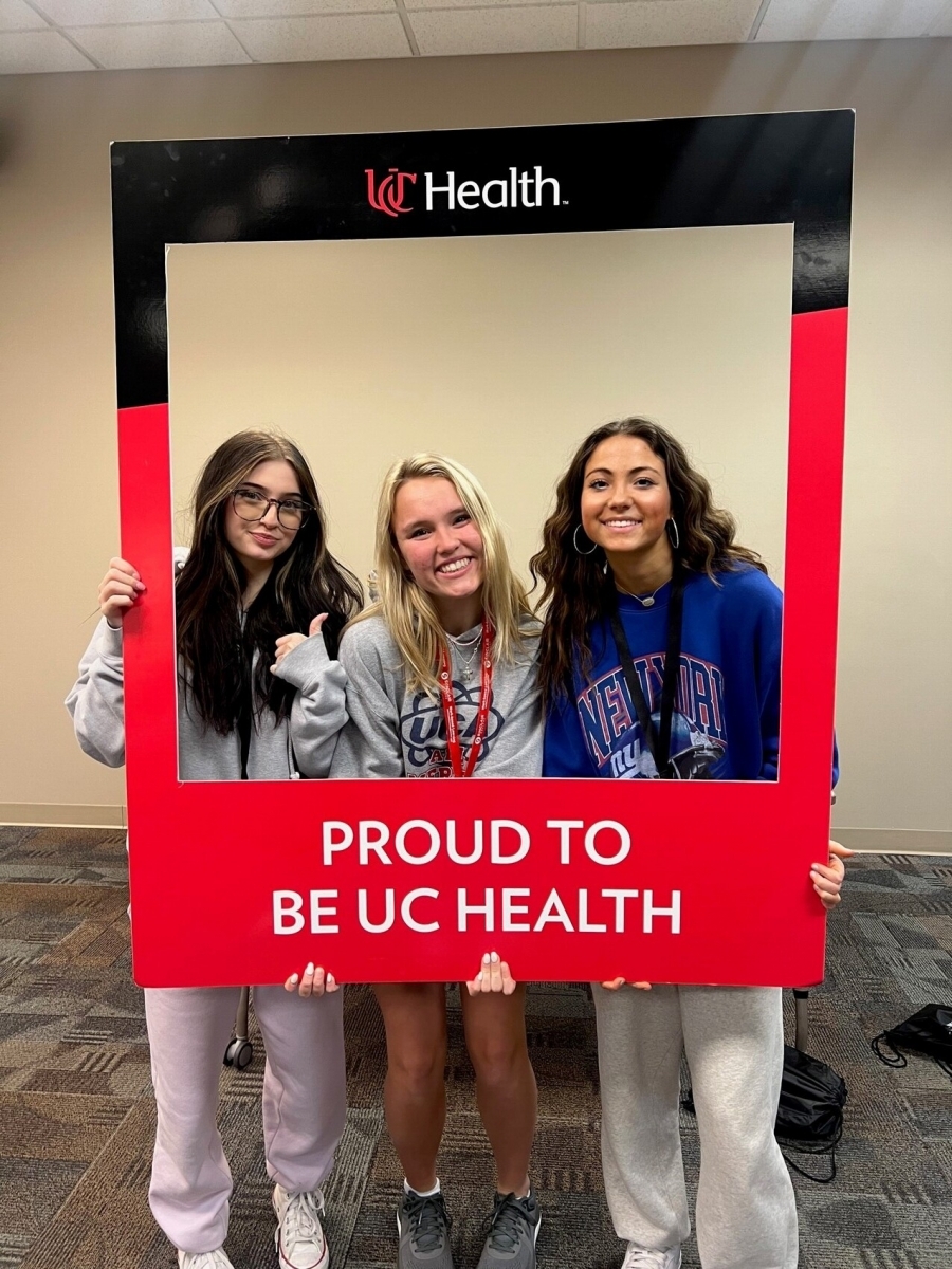 girls holding UC Health sign